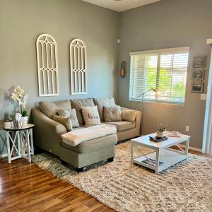 a living room with a couch and a table at LUX! 2 bd 2 ba Farmhouse condo Mesa/Phoenix metro in Mesa