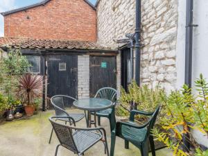 a patio with a table and chairs and a building at Duck Cottage in Bridlington