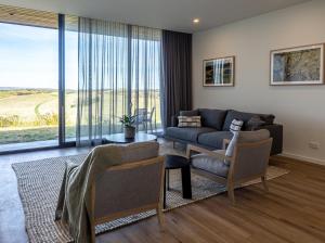 a living room with a couch and a table at Links Lodge at The Dunes in Rye