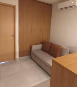 a small living room with a couch and a door at Salinas Premium Resort in Salinópolis +12 photos