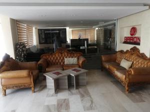 a living room with two couches and a table at Dead sea 2 bedroom apartment in Astana ,swemeh Jordan in Sowayma