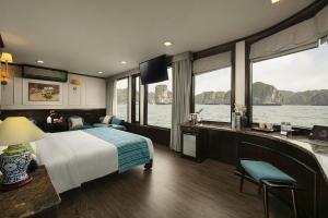 a bedroom with a bed and a view of the water at Orchid Trendy Cruise in Ha Long +27 photos