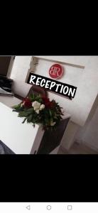 a white counter with flowers on top of it at Dead sea 2 bedroom apartment at Astana in Sowayma