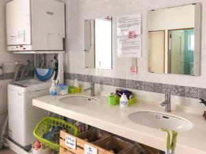 a kitchen with two sinks and a washer and dryer at Minshuku Irayoi in Ishigaki Island +106 photos