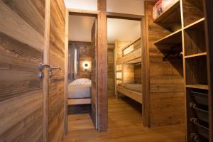a room with wooden walls and a door and a bedroom at Les Brigues - Appartement avec vue sur la montagne et accès aux pistes in Courchevel