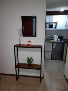 a kitchen with a table with a potted plant on it at Departamento Céntrico en Mendoza in Mendoza