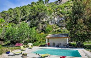 a villa with a swimming pool in front of a mountain at Gorgeous Home In Merindol in Mérindol