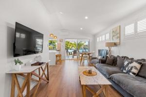 a living room with a couch and a table at Salt @ South West Rocks in South West Rocks