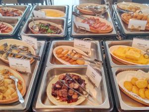 a buffet of different types of food in trays at Hotel Hakodate Royal Seaside BBH Hotel Group in Hakodate
