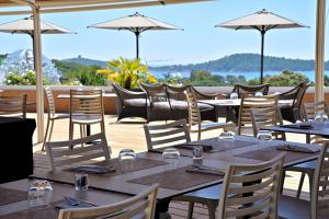 a restaurant with tables and chairs and a balcony at U Paesolu in Sainte-Lucie de Porto-Vecchio