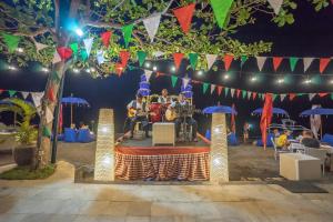 a band playing on a stage at a party at The Lovina in Lovina