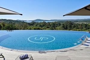 a large swimming pool with a view of the water at U Paesolu in Sainte-Lucie de Porto-Vecchio