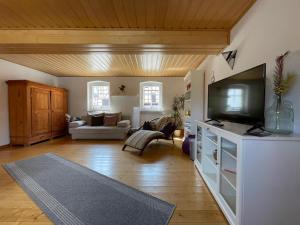 a living room with a flat screen tv on a dresser at Ferienwohnung Landliebe in Rudolstadt