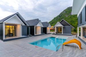 an image of a house with a swimming pool at The Chill Villa Prachuap in Khao Khan Kradaj
