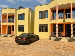 a car parked in front of a building at The Mugabis Spacious Private Room in Kigali