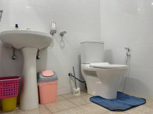 a bathroom with a sink and a toilet at The Mugabis Spacious Private Room in Kigali +43 photos