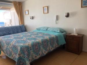 a bedroom with a bed and a wooden nightstand with a bed sidx sidx sidx at Ocean View in Viña del Mar