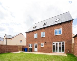 a brick house with a grey roof at New Build 5 Bedroom Detached House With Parking in Bicester