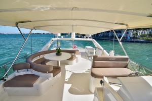 a white boat with a table on the water at Luxurious 3 bedroom yacht Also offers charters in Miami Beach