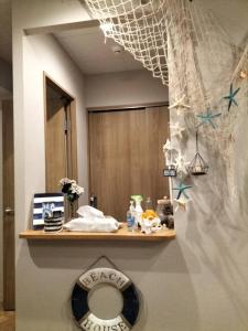 a bathroom with a toilet on a shelf with a mirror at bnb plus Ueno Park Female only in Tokyo