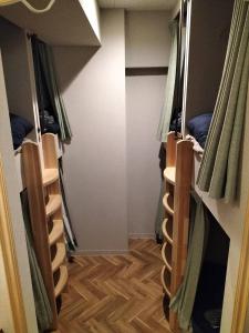 a row of bunk beds in a room at bnb plus Ueno Park Female only in Tokyo
