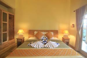 Letto o letti in una camera di The Suci Sari Ubud