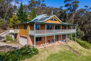 a house with a solar roof on top of it at Narrow Neck Lodge in Katoomba