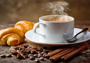 a cup of coffee on a plate with coffee beans at Las Cabanas Resort in Pushkar