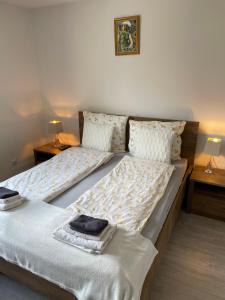 a bedroom with two beds with towels on them at Prestige Apartament in Elblag