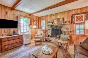a living room with a fireplace and a tv at Dan Jones in Waynesville