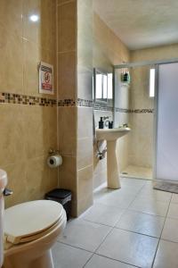 a bathroom with a toilet and a sink at 4 VENATOR House Boutique in León