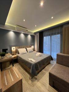 a bedroom with a bed and a large window at Oasis in Sarti