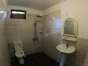a bathroom with a toilet and a sink at Freedom Beach Arugam Bay in Arugam Bay