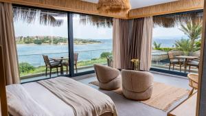 a bedroom with a bed and a view of the ocean at Sa'Rezya Hotel in Cesme