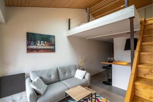a living room with a couch and a loft at CABANA & Sunset #2 - Terrasse, Parking & Lac in Veyrier-du-Lac