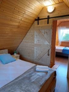 a bedroom with a bed with a barn door at Domek Gościnny in Darłowo