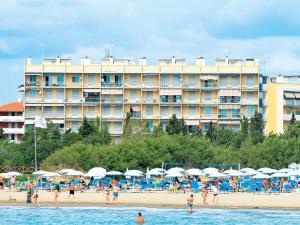 ein Hotel am Strand mit Leuten am Strand in der Unterkunft Charming holiday home in Porto Santa Margherita with terrace in Porto Santa Margherita