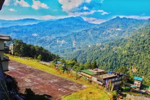an aerial view of a mountain range with a train at Mayal Retreat in Gangtok
