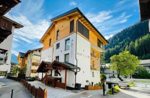 a building in the middle of a street at Quality Hosts Arlberg - ALPtyrol Appartements in Sankt Anton am Arlberg