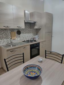 una cocina con una mesa con un tazón. en Casa dei Vespri, en Marsala