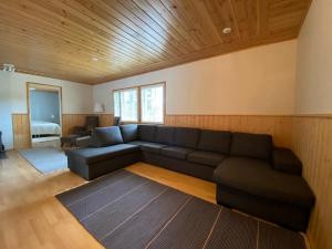 uma sala de estar com um sofá e um quarto em Moksunsalo em Ähtäri