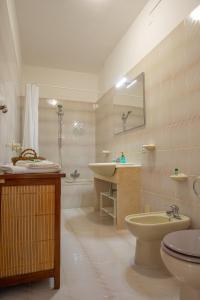 a bathroom with a sink and a toilet and a tub at Casa BabbaLuciana in Mondello +56 photos