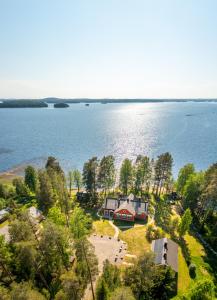 an aerial view of a house on the shore of a lake at B&B Taipaleenniemi in Savonlinna