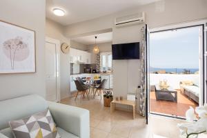 a living room with a couch and a dining room at Plaka Modern Apartment in Chania Town