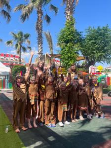 a group of children dressed in costumes posing for a picture at Orange County Belek in Belek
