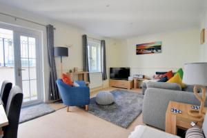 sala de estar con sofá y TV en Anning's View, en Lyme Regis