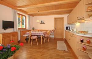 a kitchen with a table and a dining room at Niglutsch Apartement Puflatsch in Castelrotto
