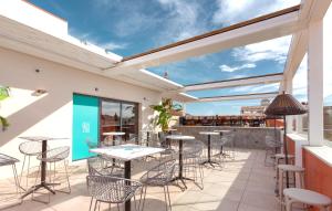 a patio with tables and chairs and a bar at Apartamentos Málaga Premium - Calle Granada in Málaga