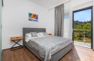 a bedroom with a bed and a large window at Casa Bella in Lopud Island