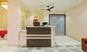 a lobby with a counter with a ceiling fan at Treebo Trend Royal Imperio in Pune